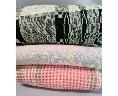 Vintage Welsh carthen on a grey ground with green and black geometric decoration together with another pink ground and blue W