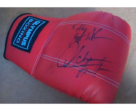 Autographed Boxing glove. Red Olympus training glove with an unidentified boxing autograph in black ink.  Good condition. All
