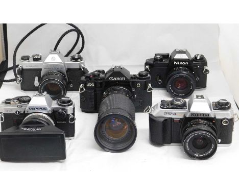 A quantity of camera's: to include an Olympus OM-10 with an Asahi Pentax Stereo Adapter; a Canon A-1 with Sirius Zoom lens f2