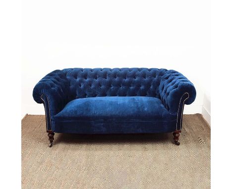 CHESTERFIELD SOFA, Victorian walnut in blue velvet on ceramic castors, 67cm H x 202cm x 85cm.