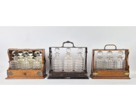 TANTALUS, Victorian oak and brass bound, together with another Victorian oak tantalus and a Betjemann coromandel tantalus. (3