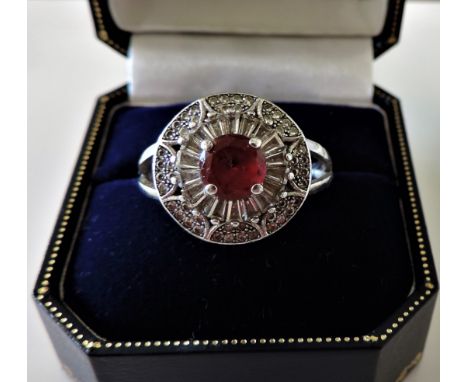 Vintage Platinum Silver Ruby Ring. A platinum on sterling silver set with a central 6mm round ruby with white gemstones set a