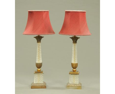 A pair of moulded glass and brass table lamps, each with shade and raised on square stepped bases.  Height including shade 86