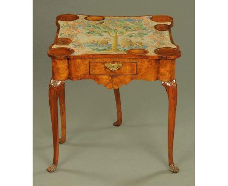 A Georgian walnut turnover top games table, with tapestry interior playing surface depicting tree, birds and lions and with c