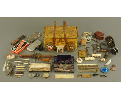 A vintage biscuit tin containing a quantity of fishing reels, Rolls razors and other collectibles.  