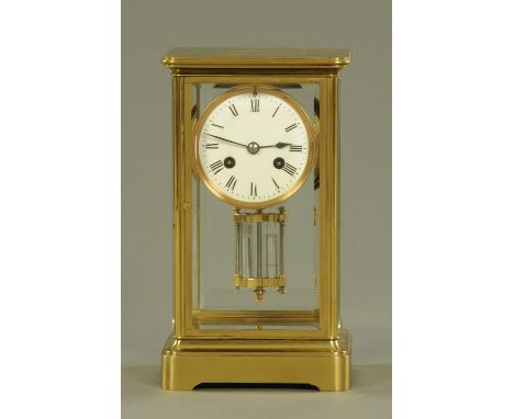 A brass four glass mantle clock, with mercury weighted pendulum and two-train striking movement.  Height 23 cm, width 13 cm.