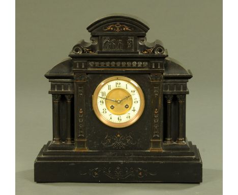 A late Victorian black slate architectural mantle clock, the silvered brass dial with Arabic numerals and with two-train move