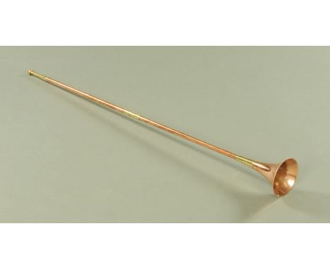 A copper coaching horn with brass fittings, 122.5 cm long. CONDITION REPORT: This horn is in good condition with only light s