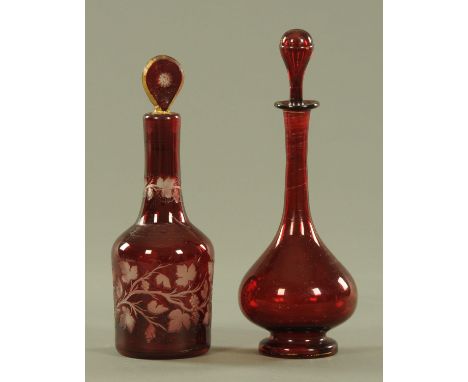 A 19th century ruby overlaid decanter, having a shaped stopper, the mallet shaped body cut through to clear with fruiting vin