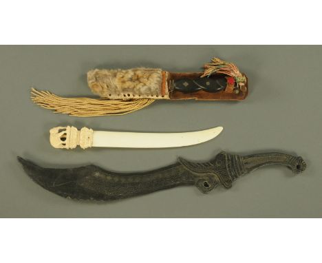 An Indian carved ivory letter opener, circa 1900, surmounted by an elephant upon a double lotus stand 27 cm, a decorative Ind