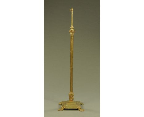 A Victorian brass lamp standard, with adjustable mechanism, Corinthian capital and square stepped base raised on paw feet.