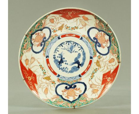 A Japanese Imari charger, late 19th century, the centre decorated with prunus, pine and bamboo framed by shaped cartouche, gi