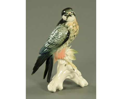 A porcelain model of a hobby by Karl Ens, 20th century, naturalistically modelled on a leafy stump, printed factory marks.  H