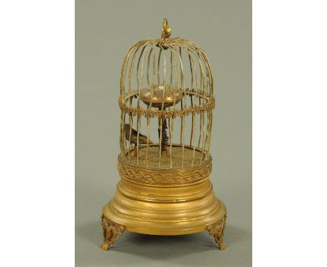 An Austrian novelty automaton timepiece, circa 1910, modelled as a bird in a cage, the clock dial in the centre modelled as a