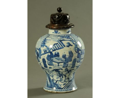 A Chinese blue and white Kangxi (1662-1722) vase, of inverted baluster form decorated with scholars either looking at scrolls