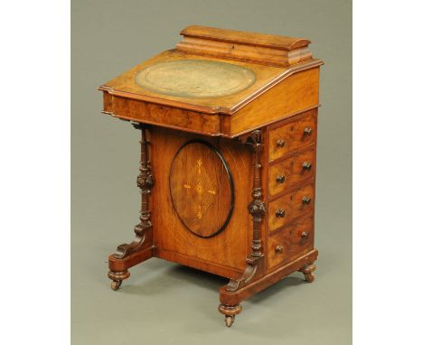 A Victorian walnut Davenport, with rear stationery compartment, slope front and fitted interior with oval centre panel, four 