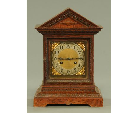 A German oak cased mantle clock, having a two train Junghans movement with two striking hammers (no gongs), the rear door wit
