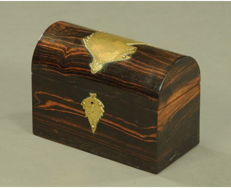 A 19th century coromandel wood tea caddy, with domed top and with applied brass leaf mouldings.  Width 23 cm. CONDITION REPOR