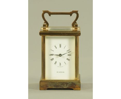 An English brass carriage clock timepiece, the enamel dial with Roman numerals inscribed H Samuel.   Height excluding handle 