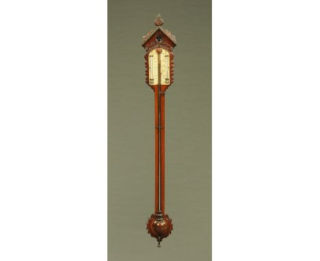 A Victorian mahogany Gothic style stick barometer, with carved head and foot, the scale marked Hele Teegnmouth.  Height 112 c