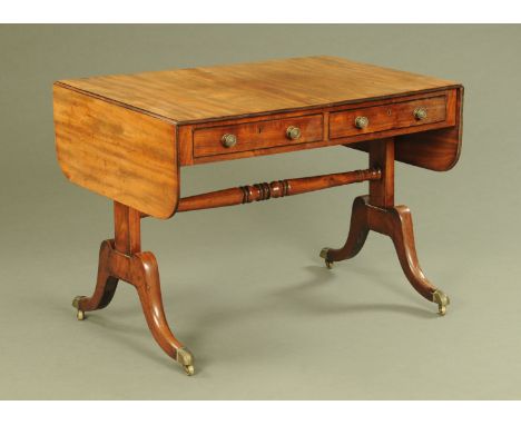 A George III mahogany sofa table, fitted with two frieze drawers and two dummy drawers, with silhouette end supports, high st