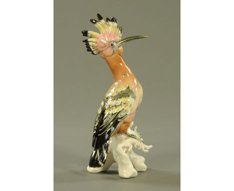 A Karl Ens porcelain model of a Hoopoe, 20th century, modelled standing upon a leafy branch, factory printed marks.  27 cm hi