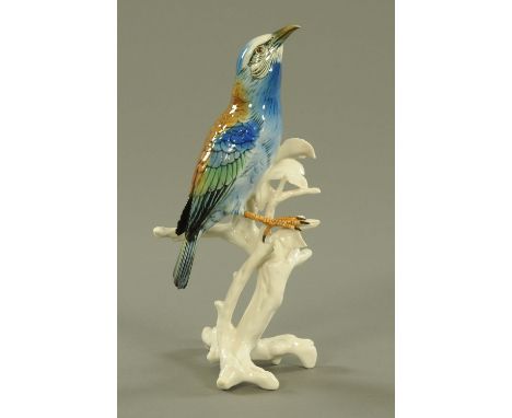 A Karl Ens porcelain figure of a Roller bird, 20th century, modelled upon a leafy branch, factory printed marks.  29.5 cm hig