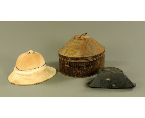A 19th century pith helmet, in tin case, bearing plaque "Gieve Matthews &amp; Seagrove" and further plaque to "E.R.W. James R