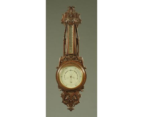 A late 19th century oak cased aneroid barometer, in the Art Nouveau style, the dial inscribed "Knibbs, Boscombe", and a Victo
