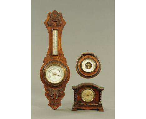 A carved oak banjo barometer, an oak cased mantle clock and circular walnut barometer.