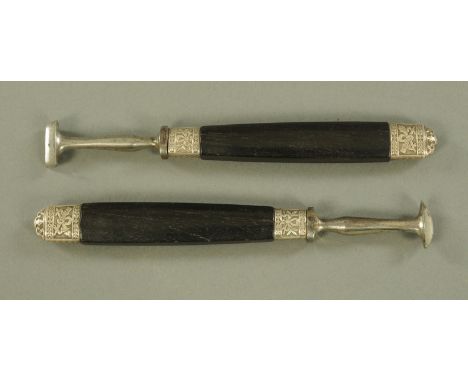 Two book binders tools, mid 19th century, with steel ends and cast metal collars with ebony handles.  16 cm.
