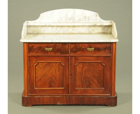 A Victorian mahogany washstand, with marble upstand and top, fitted with two drawers with cupboards beneath and with plinth b