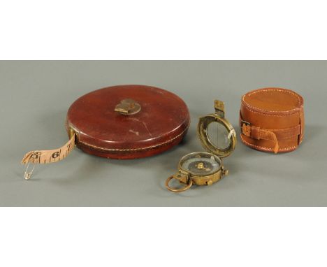 A Great War military compass, within a leather case, together with a surveyors case with brass fittings and leather cover, wi