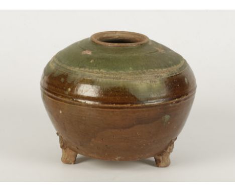 A CHINESE GREEN AND BROWN GLAZED TRIPOD JAR, Han Dynasty, of compressed cushion shape, with upper and lower blended glazes, r