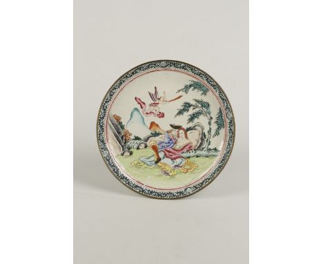 A CHINESE CANTON ENAMEL SHALLOW CIRCULAR DISH, Qianlong, the piece painted with an amorous couple recumbent near rocks, an an