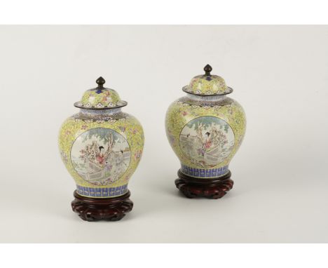 A PAIR OF CHINESE CANTON ENAMEL BALUSTER VASES AND COVERS, Qing Dynasty, each yellow ground enclosing circular panels depicti