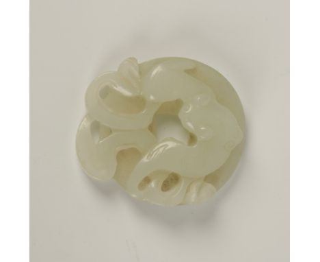 A CHINESE MOTTLED PALE CELADON JADE PENDANT centrally carved with a peony, within a lozenge and angular motifs, late Qing Dyn