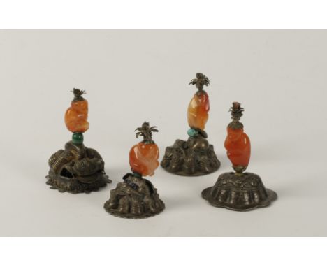 AN UNUSUAL SET OF FOUR CHINESE CARVED CORNELIAN MONKEY FINIALS, Qing Dynasty, 19th century, each mounted in white metal, repo