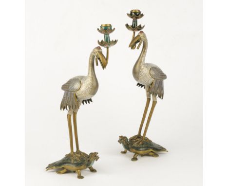 A PAIR OF CHINESE CLOISONNÉ ENAMEL CRANE AND TORTOISE CANDLESTICKS, early 20th century, each bird standing holding the lotus 