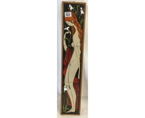 DECORATIVE CERAMIC TILE OF A FULL LENGTH FEMALE FIGURE WITH LILIES, MADE UP OF 3 TILES AND SIGNED WITH INITIALS AT