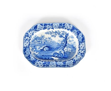 A blue and white transferware meat dish, 19th century, moulded with draining channels, printed with rabbits grazing at the ba