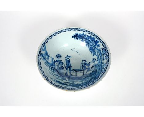 A delftware wash basin, c.1750-70, with an everted rim, painted in blue with two Chinese figures beside trees and rockwork in