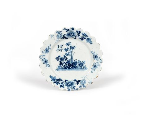 A delftware plate, dated 1757, possibly Liverpool, painted in blue with bamboo and flowering peony, inscribed 'I P 1757', the