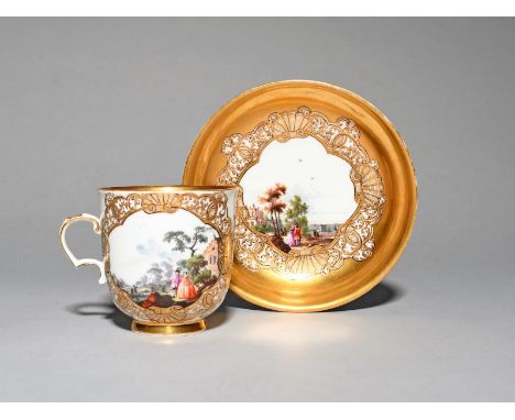 A Meissen cup and saucer, c.1740, finely painted with panels of figures standing and on horseback beside stately buildings in