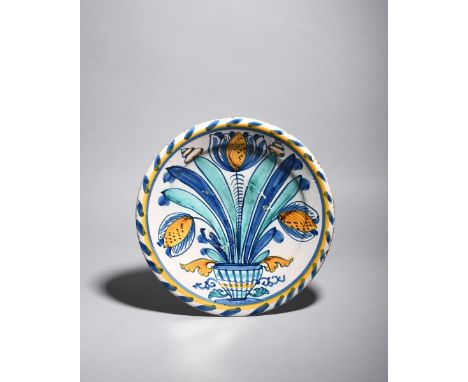 A delftware blue dash tulip charger, c.1680, probably Brislington, boldly painted with three tulips and long straight leaves 