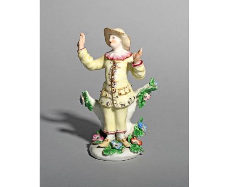 A rare Bow figure of Pedrolino or Pierrot, c.1755, from the Commedia dell'Arte, wearing a yellow costume edged in purple penc