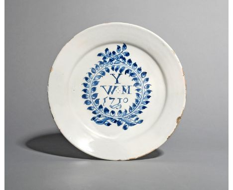 An English delftware plate, dated 1710, inscribed in blue with the letter Y over the initials W M above the date 1710, all wi
