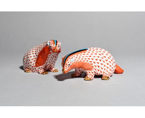 A pair of Herend models of badgers, modern, each decorated with stripes of red, blue, black and gilt issuing from their snout
