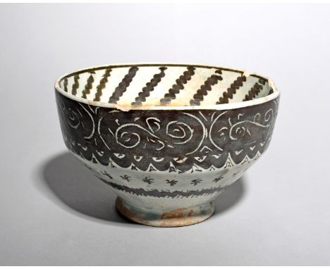 An Islamic pottery bowl, probably 19th century, of ogee form, the sides with sgraffito decoration of scrolling foliage above 