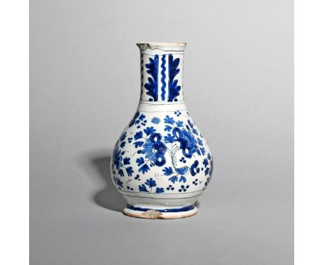 A London delftware bottle or vase, c.1700-20, painted in blue and black with a dense floral design, the tall neck with styliz